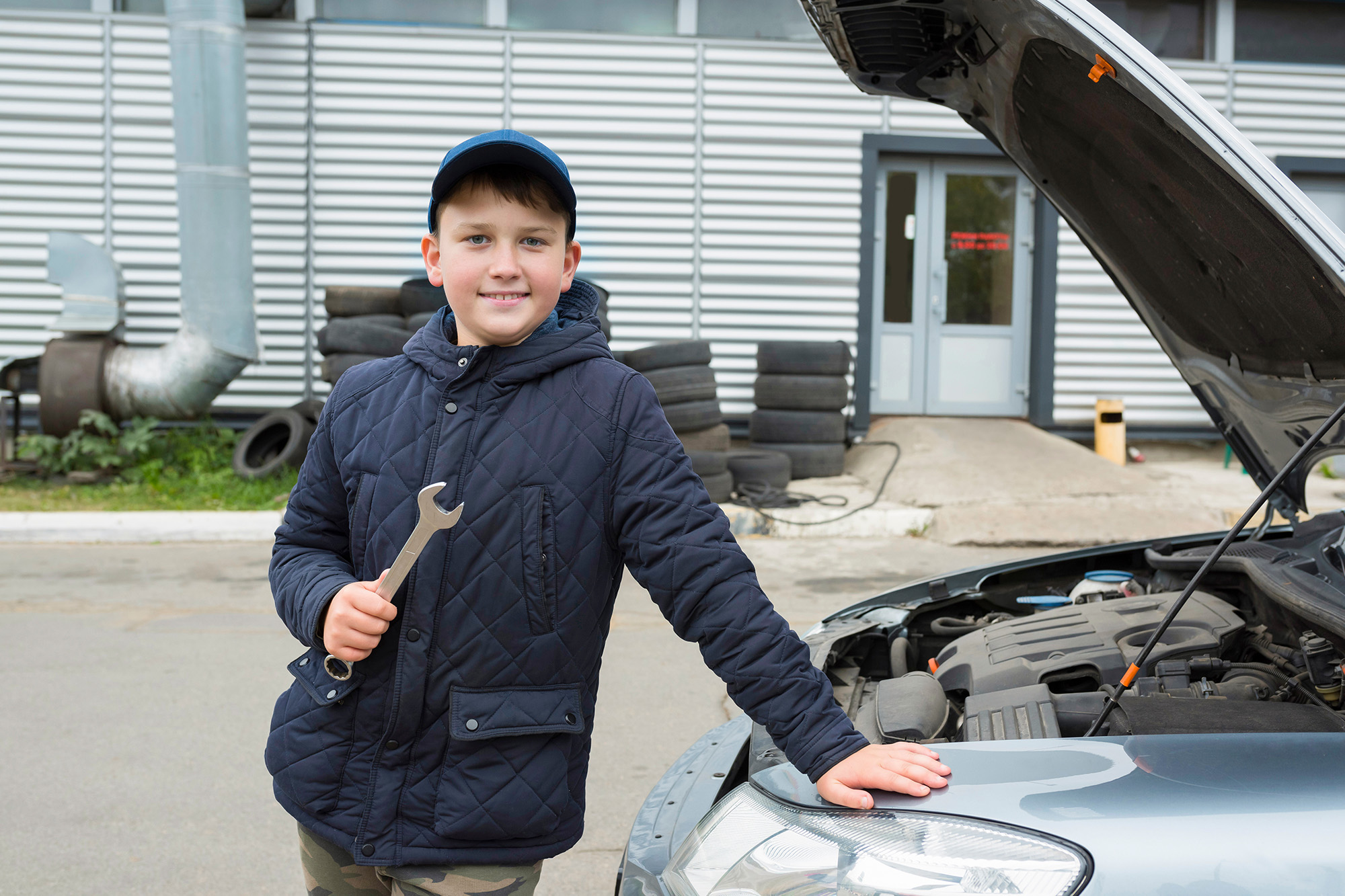 Teenage boy holding a wrench