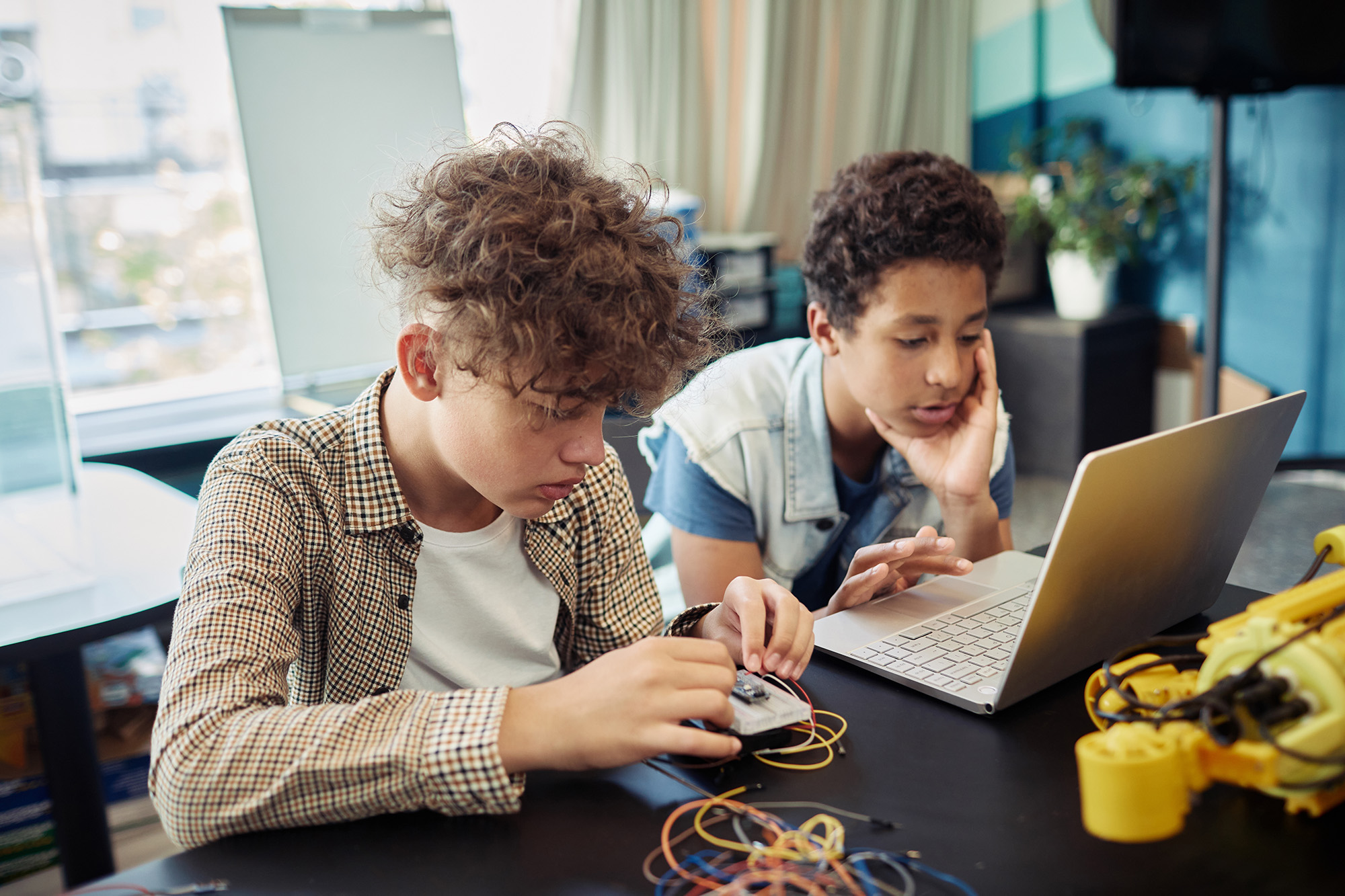 Two teenage boys working on a science project